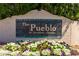 Attractive community sign, 'The Pueblo at Anderson Springs', surrounded by lush flowers and landscaping at 333 N Pennington Dr # 63, Chandler, AZ 85224