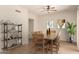 Dining room with wood-look floors, a ceiling fan, shelving and a wooden table with seating for six at 333 N Pennington Dr # 63, Chandler, AZ 85224