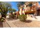 Paver pathway leading to homes with stucco walls, patios, balconies, and desert landscaping at 333 N Pennington Dr # 63, Chandler, AZ 85224