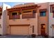 Inviting two-story townhome with a private balcony, garage, and charming desert landscaping at 333 N Pennington Dr # 63, Chandler, AZ 85224