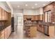 The updated kitchen features wood cabinetry, granite counters, stainless appliances and brick accents at 333 N Pennington Dr # 63, Chandler, AZ 85224
