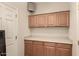 This laundry room features wooden cabinets and a white countertop at 333 N Pennington Dr # 63, Chandler, AZ 85224