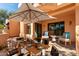 Private patio with a large umbrella, outdoor dining set, and comfortable seating, perfect for entertaining at 333 N Pennington Dr # 63, Chandler, AZ 85224