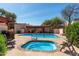 Community pool and hot tub surrounded by desert landscaping at 333 N Pennington Dr # 63, Chandler, AZ 85224