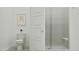 Clean bathroom with toilet and glass door shower featuring marble-patterned walls, and neutral wall art for a serene feel at 3783 E Gold Mountain Ave, San Tan Valley, AZ 85143