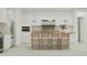 Bright, modern kitchen with white cabinets, stainless steel appliances, and a spacious island with bar stool seating at 3783 E Gold Mountain Ave, San Tan Valley, AZ 85143