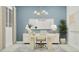 Stylish home office with blue walls, modern chandelier, decorative lamps and spacious desk providing a serene workspace at 3783 E Gold Mountain Ave, San Tan Valley, AZ 85143
