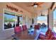 Covered patio with a table, ceiling fans, and outdoor access at 3818 N Kalispell Ct, Casa Grande, AZ 85122