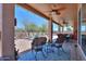 A spacious covered patio featuring ceiling fans, seating, and a view of the backyard and pool at 3818 N Kalispell Ct, Casa Grande, AZ 85122