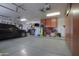 Well-lit garage with a car parked inside and organized storage along the walls at 3818 N Kalispell Ct, Casa Grande, AZ 85122