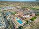 Expansive aerial view highlighting community amenities, including pools, tennis courts, and parking at 4297 E Pyrenees Ct, Gilbert, AZ 85298