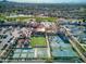 Aerial view showcasing the community's impressive recreational amenities, including pools, tennis courts, and lush green spaces at 4297 E Pyrenees Ct, Gilbert, AZ 85298