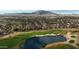 Stunning aerial view of a meticulously maintained golf course and upscale residential community in a serene setting at 4297 E Pyrenees Ct, Gilbert, AZ 85298