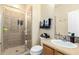 Well-lit bathroom featuring tiled shower with glass door and decorated with cactus themed towels at 4297 E Pyrenees Ct, Gilbert, AZ 85298