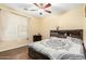 Cozy bedroom with hardwood floors, a ceiling fan, and a window offering plenty of natural light at 4297 E Pyrenees Ct, Gilbert, AZ 85298