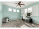 Bright bedroom provides ample light with its window setup, ceiling fan, and dog crate at 4297 E Pyrenees Ct, Gilbert, AZ 85298