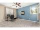 Clean and spacious carpeted room with bright blue accent wall and a window at 4297 E Pyrenees Ct, Gilbert, AZ 85298
