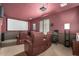 Home theater room with projector, screen, tiered seating, and dim mood lighting at 4297 E Pyrenees Ct, Gilbert, AZ 85298