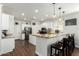 Bright kitchen features white cabinets, granite countertops, stainless steel appliances, and an island with barstool seating at 4297 E Pyrenees Ct, Gilbert, AZ 85298