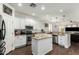 Stylish kitchen with stainless steel appliances, granite countertops, a center island, and a seamless flow to the living area at 4297 E Pyrenees Ct, Gilbert, AZ 85298