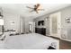 Comfortable main bedroom with hardwood floors, a ceiling fan, updated furniture, and lots of natural light from the windows at 4297 E Pyrenees Ct, Gilbert, AZ 85298