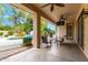 Covered patio has lounge chairs, ceiling fans, outdoor television, and a beautiful pool view at 4297 E Pyrenees Ct, Gilbert, AZ 85298