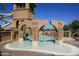A detail shot of the attractive pool features including archways, rock features, and tiled entry at 4297 E Pyrenees Ct, Gilbert, AZ 85298