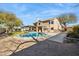 Spacious backyard features a sparkling pool, covered patio, and well-manicured lawn at 4617 E Montgomery Rd, Cave Creek, AZ 85331