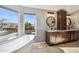 Bathroom featuring a soaking tub, wood cabinets, granite countertop, and views to the back yard at 4617 E Montgomery Rd, Cave Creek, AZ 85331