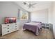 Cozy bedroom featuring neutral carpet, a ceiling fan, and a mounted TV on a white dresser at 4617 E Montgomery Rd, Cave Creek, AZ 85331