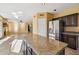 Open concept kitchen flows into living room with stainless steel refrigerator and granite island at 4617 E Montgomery Rd, Cave Creek, AZ 85331