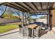 Outdoor dining on a covered patio with stylish furniture set in a well-maintained backyard at 4617 E Montgomery Rd, Cave Creek, AZ 85331