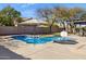 Sparkling pool in a private backyard, featuring mature trees, an umbrella, and outdoor seating at 4617 E Montgomery Rd, Cave Creek, AZ 85331