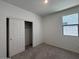 Bedroom features neutral carpet, a sliding-door closet, and a sunlit window at 47734 W Moeller Rd, Maricopa, AZ 85139