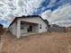 This new home features a covered patio and stucco exterior in a natural desert landscape at 47734 W Moeller Rd, Maricopa, AZ 85139