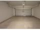 Spacious garage with a rolling door, offering ample space for parking and storage at 47734 W Moeller Rd, Maricopa, AZ 85139
