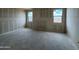 Unfinished room featuring bare walls and concrete floor, offering a bright and customizable layout at 47734 W Moeller Rd, Maricopa, AZ 85139