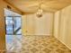 View of the dining room featuring tile floors, neutral walls, a chandelier, and sliding doors to the exterior at 5040 N 69Th Dr, Glendale, AZ 85303