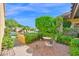 View of the front yard with a seating area nestled within the lush landscaping at 5505 E Mclellan Rd # 41, Mesa, AZ 85205