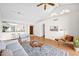 Bright living room featuring a high ceiling, hardwood floors, a ceiling fan, and an open layout at 5505 E Mclellan Rd # 41, Mesa, AZ 85205