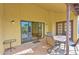 Cozy covered patio with stone flooring, dining set, and access to the home's interior at 5505 E Mclellan Rd # 41, Mesa, AZ 85205