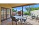 Inviting covered patio with stone flooring, dining set, and views of lush greenery and golf course at 5505 E Mclellan Rd # 41, Mesa, AZ 85205