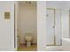 Bathroom with a toilet and a shower with gold trim and glass doors at 5742 W Shannon St, Chandler, AZ 85226