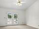 Bedroom featuring double doors leading to the backyard, a ceiling fan and neutral carpet at 5742 W Shannon St, Chandler, AZ 85226