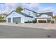 Beautiful home with a white exterior, large windows, and a well-maintained yard at 5742 W Shannon St, Chandler, AZ 85226