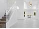 Bright living room with high ceilings, large windows, and a staircase at 5742 W Shannon St, Chandler, AZ 85226