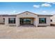 Back of house showing the covered patio and large windows at 5779 N 207Th Ave, Buckeye, AZ 85396