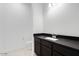 Modern powder room featuring dark cabinetry, solid surface counters, and new plumbing fixtures at 5779 N 207Th Ave, Buckeye, AZ 85396