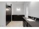 Modern bathroom showcasing dual vanities, granite countertops, and a glass-enclosed shower at 5779 N 207Th Ave, Buckeye, AZ 85396