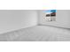 Bright bedroom featuring a large window, plush carpeting and neutral paint at 5779 N 207Th Ave, Buckeye, AZ 85396